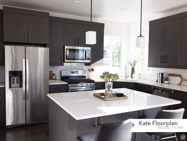 Kitchen with appliances with stainless steel finishes, a kitchen breakfast bar, and backsplash | Image 6