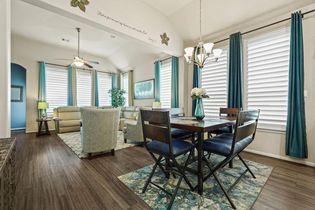 This open-concept area is a dynamic space ready for various functions. Imagine a vibrant dining area flowing into a comfortable living room, perfect for entertaining or daily life. The large windows offer abundant natural light, ideal for creating a bright and inviting atmosphere. | Image 12