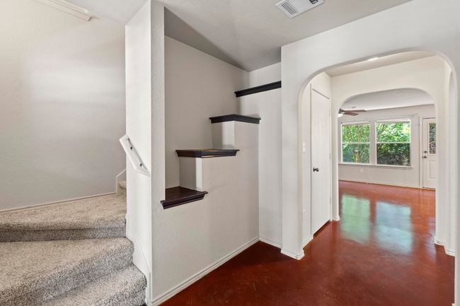 The entrance foyer provides views of the carpeted staircase and the common area. | Image 4