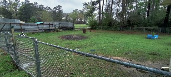 View of fenced backyard | Image 9