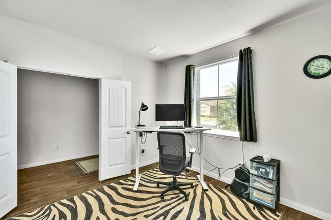 Office space with wood finished floors and baseboards | Image 6