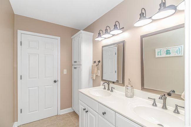 Full bath featuring double vanity and tile patterned floors | Image 30