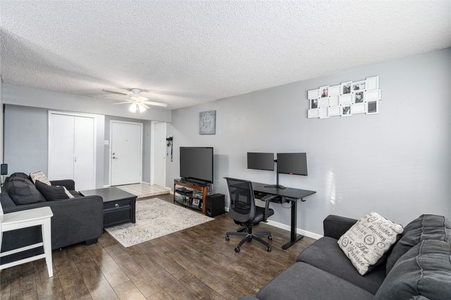 Living Room featuring ceiling fan and dark hardwood / wood-style flooring | Image 9