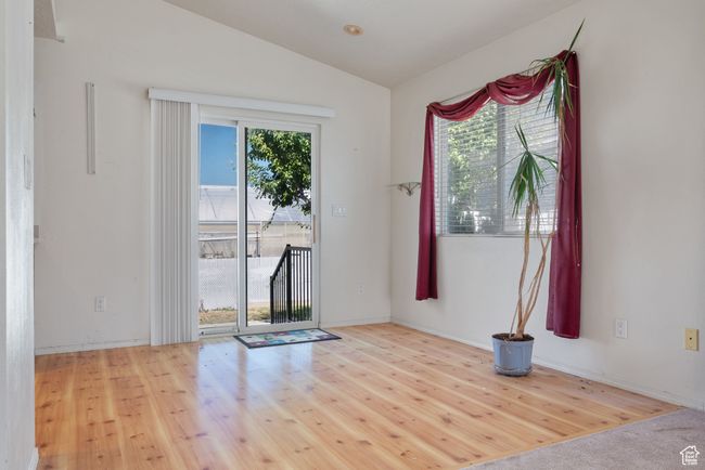 Entryway with lofted ceiling and wood finished floors | Image 8