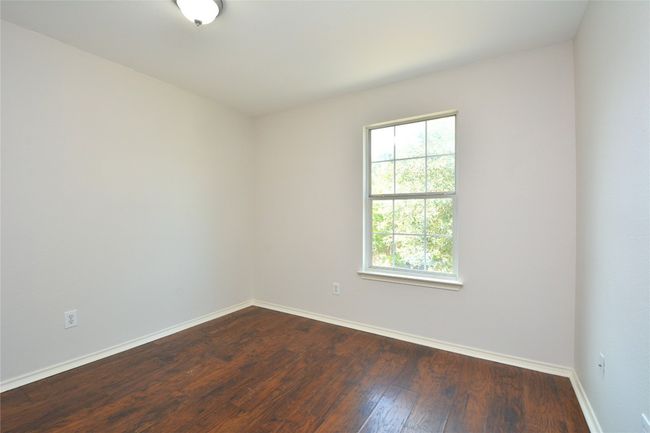 Spare room featuring baseboards and dark wood finished floors | Image 16