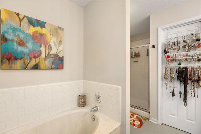 The primary en-suite includes a separate tub and shower—imagine starting your mornings with a quick rinse or winding down in a relaxing soak after a long day. There's plenty of room here to create a spa-like atmosphere that suits your style. | Image 14