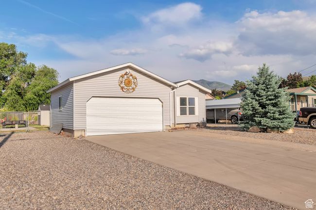 View of front facade featuring driveway and an attached garage | Image 21
