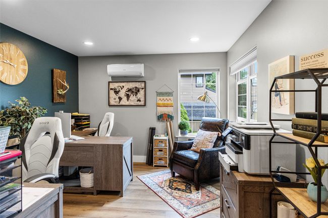 Office area with an AC wall unit, light wood-style flooring, and recessed lighting | Image 9