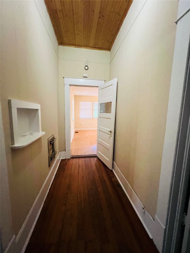 Hallway with wood ceiling, dark wood-type flooring, and heating unit | Image 21