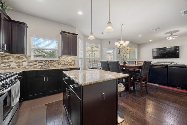 The center island is perfect for preparing your meals and comes with inviting bar seating for two that everyone will want to gather around. | Image 16