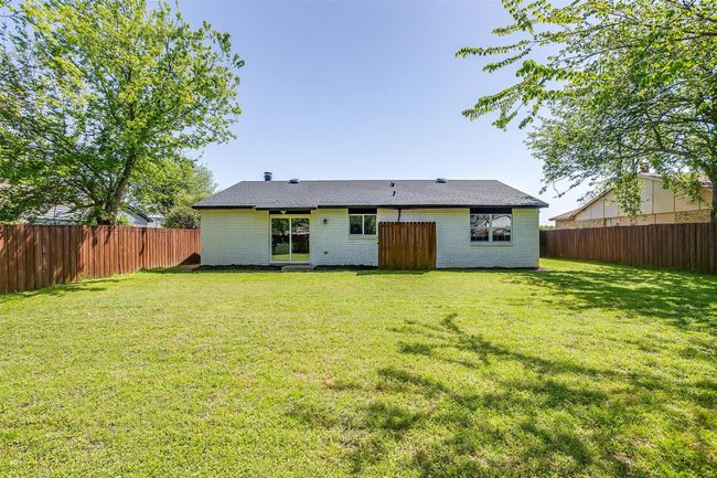 Back of property with brick siding and a fenced backyard | Image 29