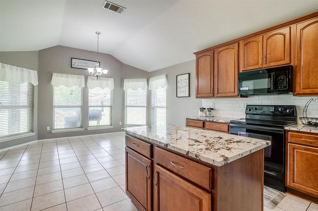 Kitchen with island. | Image 22