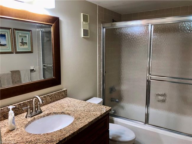 Bathroom with vanity, toilet, and combined bath / shower with glass door | Image 18