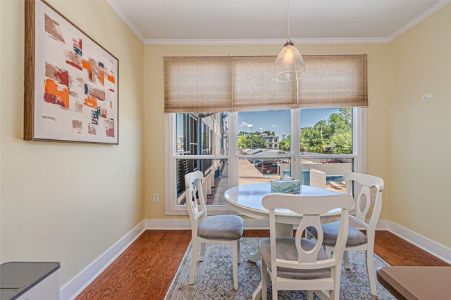 Dining area featuring wood finished floors and ornamental molding | Image 10