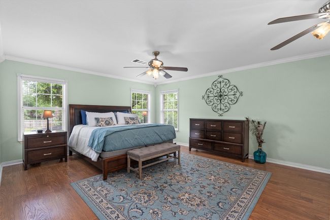 The Texas-sized primary suite is a true retreat with French door entry, crown molding, and sitting area. | Image 24