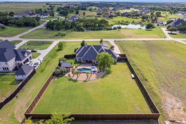 Aerial perspective of suburban area with a large body of water and a pool | Image 37
