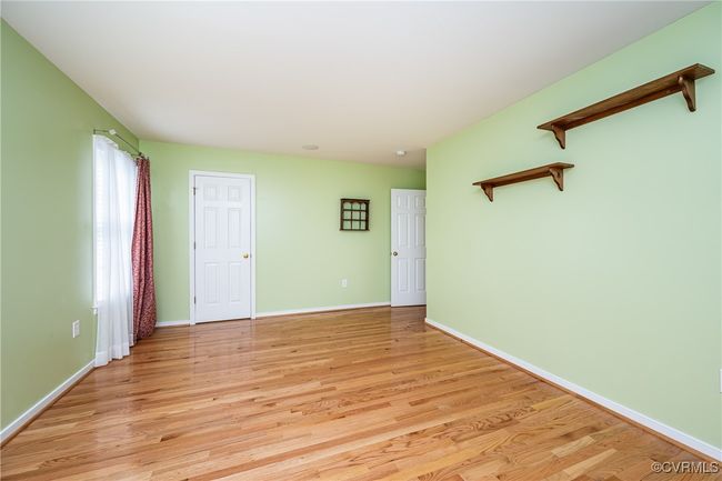 Unfurnished room with light wood finished floors and baseboards | Image 19
