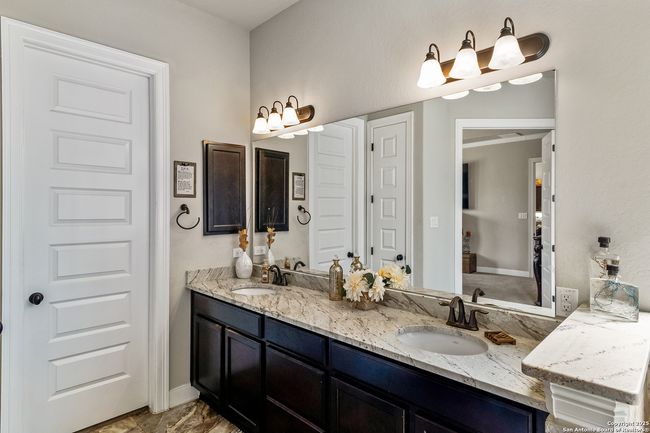 A modern bathroom featuring a sink, a shower, a to | Image 40