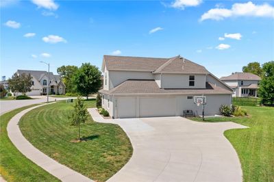 View of front facade with a garage and a front lawn | Image 2