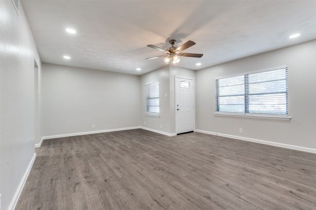 Empty room featuring a ceiling fan, wood finished floors, and recessed lighting | Image 6