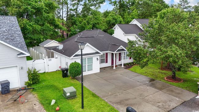 Traditional-style home with a gate and a shingled roof | Image 30