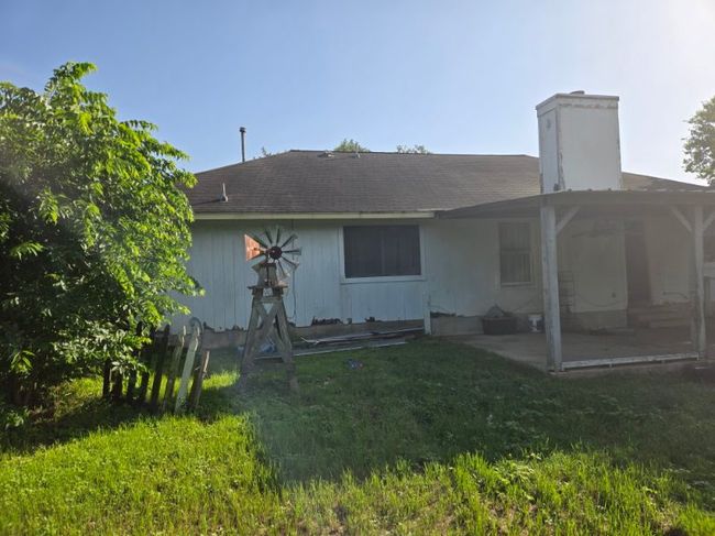 Rear view of property with a patio area, a chimney, and a yard | Image 11