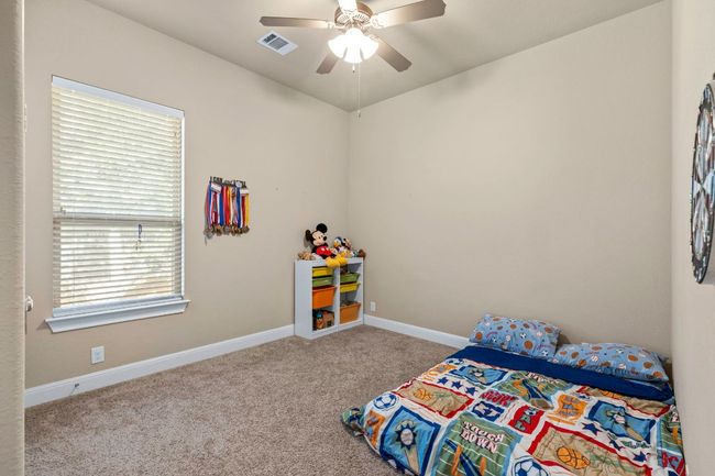 Carpeted bedroom with multiple windows and ceiling fan | Image 15