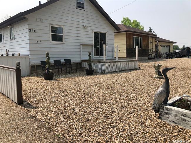 Rear view of house with a deck and a garage | Image 6