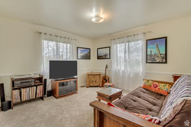 Living room with carpet flooring and a healthy amount of sunlight | Image 33