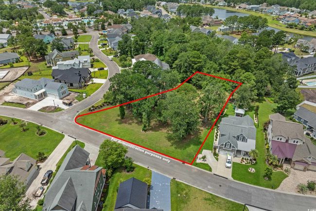 Aerial perspective of suburban area with property parcel outlined and a nearby body of water | Image 6