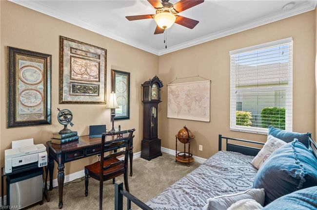Bedroom featuring carpet, ornamental molding, baseboards, multiple windows, and a desk | Image 31