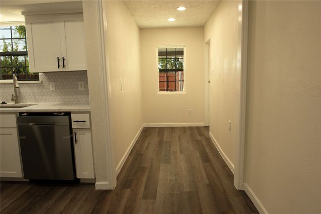 Hall with sink, a textured ceiling, and dark wood-type flooring | Image 24