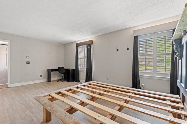 Unfurnished bedroom featuring baseboards, wood finished floors, and a textured ceiling | Image 17