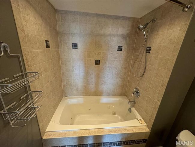 Bathroom with toilet and tiled shower / bath combo | Image 29