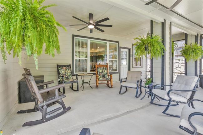 Step outside to your own private outdoor retreat. The expansive covered patio provides year-round enjoyment with room for outdoor dining, lounging, or watching the sunset in peace. It’s the perfect backdrop for grilling with friends, sipping morning coffee, or simply taking in the fresh air—rain or shine. | Image 38