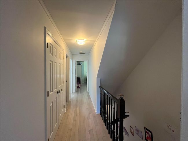 Corridor featuring crown molding, an upstairs landing, visible vents, and light wood-style floors | Image 6