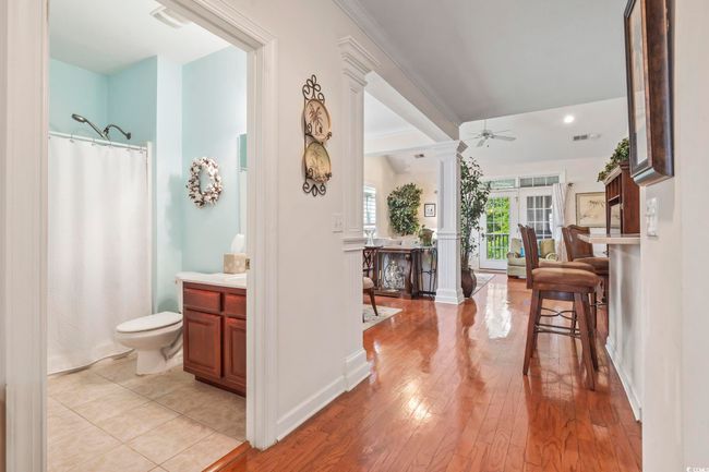 Hall with ornamental molding, light wood-style floors, and ornate columns | Image 23