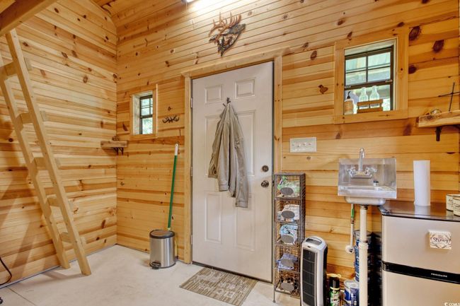Foyer featuring wood walls and concrete floors | Image 33