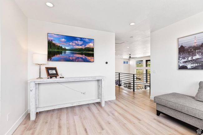 Sitting room with recessed lighting, an upstairs landing, light wood-type flooring, and baseboards | Image 47