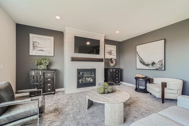 Photo is of the model. This modern fireplace is an extraordinary room accent. Enjoy the warmth of this gas fireplace as you relax in the great room. | Image 8