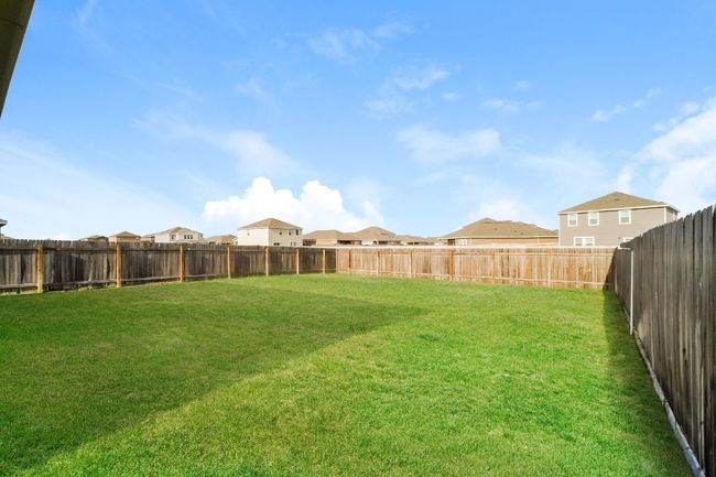 Fenced backyard with a residential view | Image 26