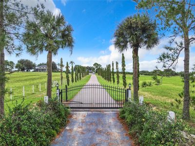 Enter the gated property and follow the tree-lined driveway to this custom built 5 bedroom, 4 bath, pool home which boasts impeccable craftsmanship. | Image 3