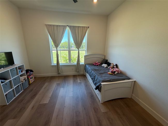 Bedroom featuring wood finished floors and recessed lighting | Image 9