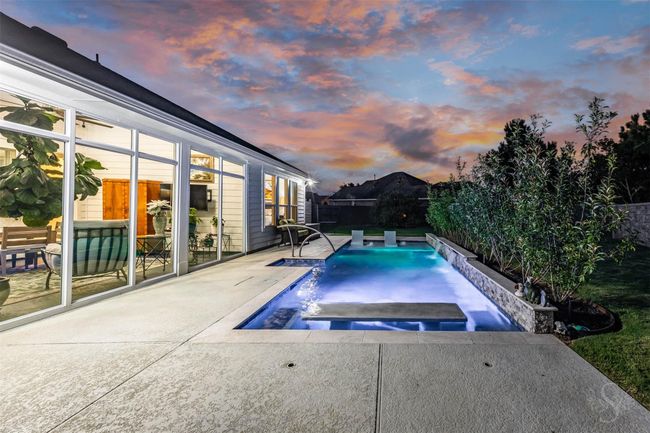 Around the pool table, comfortable seating invites guests to relax and enjoy the serene environment. In the background, adding to the modern aesthetic, is a newly built sun room, completed in 2023. | Image 5