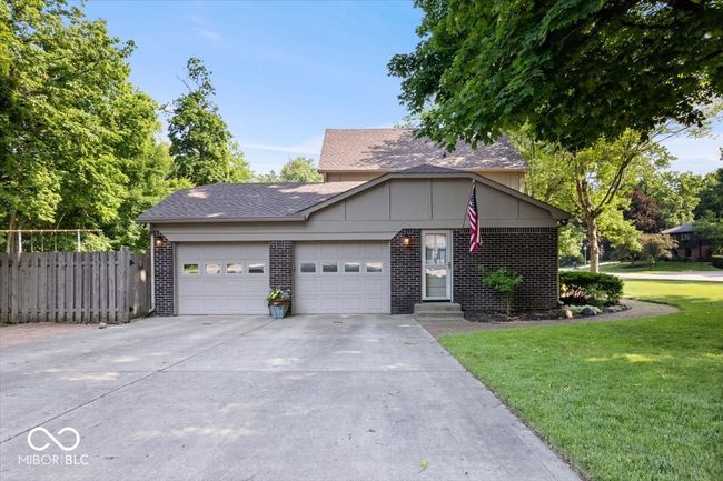 view of front of home featuring an attached garage, brick siding, driveway, entry steps, and roof with shingles | Image 40