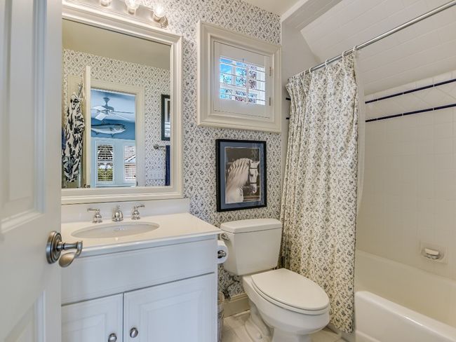 Bathroom featuring vanity, toilet, shower / bathtub combination with curtain, and wallpapered walls | Image 22