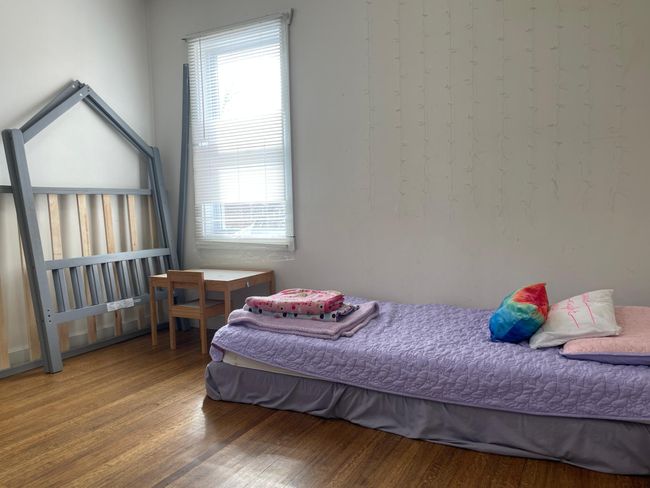 main level bedroom with hardwood floors (faces front/street view) | Image 14