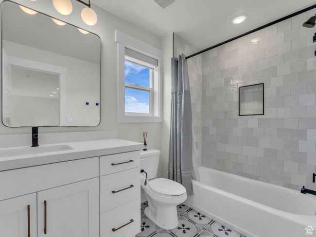 Full bathroom with tile patterned flooring, toilet, vanity, shower / bath combo, and recessed lighting | Image 45