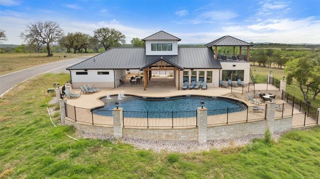 Back of property featuring a gazebo, metal roof, a patio area, and brick siding | Image 17