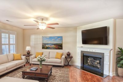 Living room with ceiling fan and wood-type flooring | Image 2